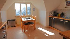 a kitchen with a table and chairs in a room at The Lookout at Lauriston in Dartmouth
