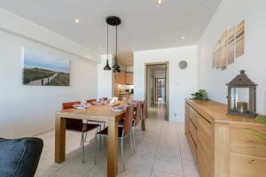 a dining room and kitchen with a table and chairs at Beachfront apartment in Zeebrugge in Bruges