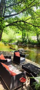 a group of chairs and tables next to a river at Luxury Resort Riverfront with Pool&Sports in Višegrad