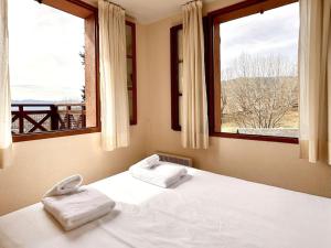 EnveitgにあるApartamento en Enveitg, Montana Parkのベッドとタオル2枚のある寝室