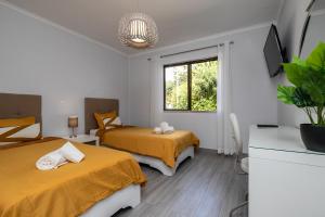 a room with two beds and a window at Apartment in São Rafael Albufeira Beach Resort in Albufeira