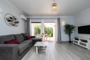 a living room with a couch and a table at Apartment in São Rafael Albufeira Beach Resort in Albufeira