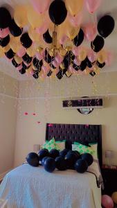 a room with a bed with a bunch of balloons at DreamWest Living The Guesthouse in Krugersdorp