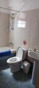 a bathroom with a toilet and a sink at Faros Beach in Paphos