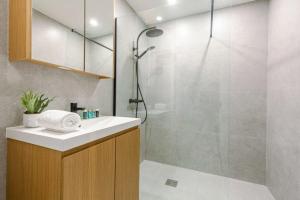 a bathroom with a shower and a sink and a shower at Huswell - Luminous family apartment with magnificent view in Ostend