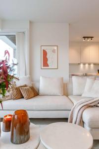 a living room with a couch and a table at Huswell - Luminous family apartment with magnificent view in Ostend