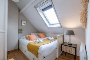 a bedroom with a bed with a skylight at Huswell - Charming town-house in the center of Bruges in Bruges