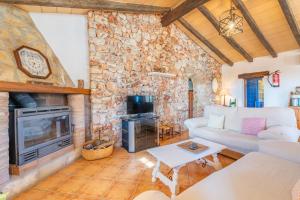a living room with a couch and a fireplace at Ses Oliveres in Campos