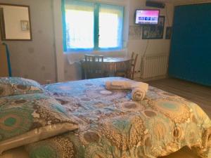 een slaapkamer met een bed met handdoeken erop bij Chambre et sanitaires privés in Épinal