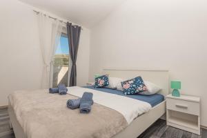 a bedroom with two beds and a window at Holiday Home Family Fun in Grebaštica +46 photos