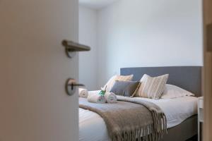 a bedroom with a bed with towels on it at Pleasant apartment at the lighthouse in Ostend in Ostend