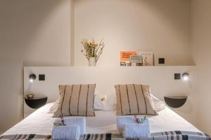 a bedroom with a white bed with two chairs at WAY SWEET DREAMS - Room 5 in Ghent