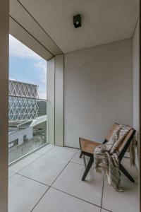 a balcony with a bench and a view of a building at Huswell - Beautiful apartment in the heart of Antwerp in Antwerp
