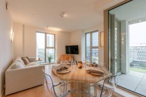 a living room with a table and a couch at Huswell - Beautiful apartment in the heart of Antwerp in Antwerp