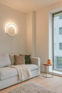 a living room with a couch and a table at Huswell - Beautiful apartment in the heart of Antwerp in Antwerp