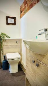 a bathroom with a sink and a toilet at The Wellington Pub Cromer in Cromer