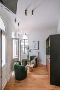 a living room with two green chairs and a table at Modern apartment in the centre of Antwerp in Antwerp