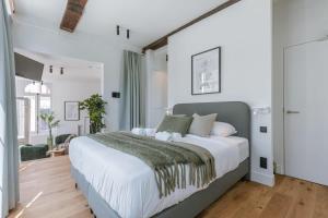 a bedroom with a large bed with white walls at Modern apartment in the centre of Antwerp in Antwerp