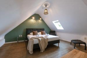 a bedroom with a large bed in a attic at Great apartment in the heart of Ypres in Ieper