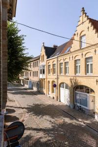 an empty street in a town with buildings at Great apartment in the heart of Ypres in Ieper