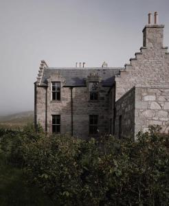 an old stone house on top of a hill at Gairnshiel lodge - Unique & exclusive lodge next to the castle in Ballater