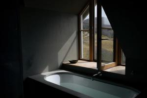 a bathroom with a sink and a window at Inverenzie - Luxury farmhouse with mountain views 