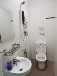 a bathroom with a white toilet and a sink at 184 GURNEY DRIVE PENANG in George Town