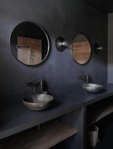 two sinks in a bathroom with two mirrors at Gairnshiel lodge - Unique & exclusive lodge next to the castle in Ballater