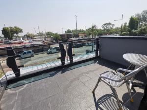 a balcony with chairs and a view of a parking lot at 184 GURNEY DRIVE PENANG in George Town