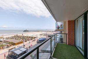 a view of the beach from a balcony of a building at Frontal seaview apartment in Blankenberge in Blankenberge