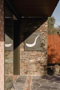 a building with two signs on a stone wall at Boutique Hotel Villa Salvador - Adults Only by Fimedhotels in Cadaqués +126 photos