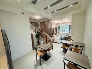 a dining room with tables and chairs in a room at Hualien Wazuka Homestay in Hualien City