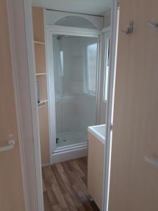 a bathroom with a shower and a tub at camping le novela in Port-la-Nouvelle