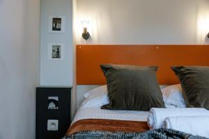 a bed with an orange headboard in a bedroom at Characterful apartment for two in central Ghent in Ghent