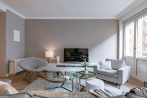 a living room with a couch and a table at Huswell - Modern apartment in heart of Knokke with terrace in Knokke-Heist