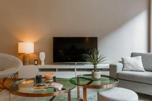 a living room with a couch and a table at Huswell - Modern apartment in heart of Knokke with terrace in Knokke-Heist