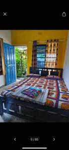 a large bed in a room with blue doors at Peace and love stay in Alleppey