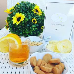 a table with a glass of orange juice and some food at Hotel le 3 lanterne in Marina di Sibari