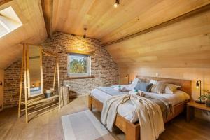 1 dormitorio con 1 cama grande en una pared de ladrillo en Authentic vacation home 'De Blauwe Kroon', en Oostkamp