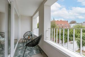 een balkon met 2 stoelen en een tafel. bij Spacious apartment in Kortrijk in Kortrijk