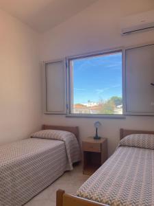 Postel nebo postele na pokoji v ubytování Villaggio Quattro Scogli + 37 fotografií