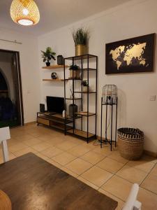 a living room with a shelf with plants on it at Jupiter Sweet Apartments - Algarve - Praia Vale centeanes in Lagoa