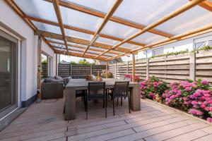 a patio with a table and chairs under a pergola at Spacious house with garden and parking in Blankenberge