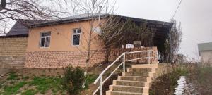 a brick house with stairs leading up to it at Sərin göl istirahət mərkəzi in Quba