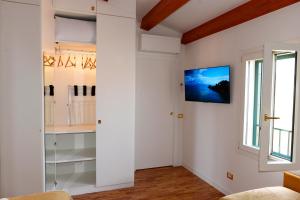 a living room with a tv on the wall at Cùninarum Domus in Alghero