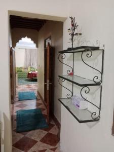 a hallway with shelves on the wall with a room at Appartement à côté de l'aéroport in Marrakesh