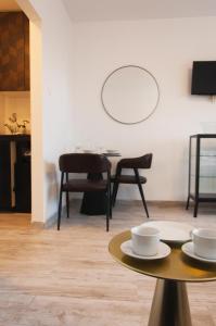 a dining room with a table and chairs and a mirror at Work & Stay Zagreb in Zagreb