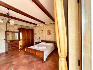 a bedroom with a bed in a room at Luxury Accommodation in Santa Domenica