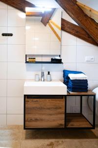 a bathroom with a sink and a mirror at Kníže Ferdinand Apartments in Mikulov