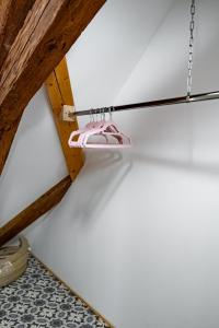 a pair of pink shoes hanging from a ceiling at Kníže Ferdinand Apartments in Mikulov